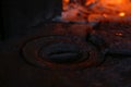 Defocus wood burning stove. Iron burner close-up antique. Firewood burning in old stove or oven. Dark and black. Orange