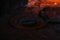 Defocus wood burning stove. Iron burner close-up antique. Firewood burning in old stove or oven. Dark and black. Orange
