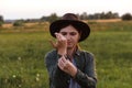 Defocus young woman in cowboy hat. Girl in a cowboy hat in a field. Sunset. Nature background. Closeup portrait Royalty Free Stock Photo