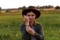 Defocus young woman in cowboy hat. Girl in a cowboy hat in a field. Sunset. Nature background. Closeup portrait Royalty Free Stock Photo