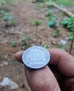 defocused abstract of an ancient Indonesian coin worth 50 rupiah.