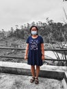 Defocused abstract background of an Asian woman wearing a facemask and wearing a dark blue dress is taking a photo at a playground