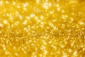 Defocused abstract colorful twinkle light background.  Gold glittery bright shimmering background use as a design backdrop. Royalty Free Stock Photo