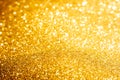 Defocused abstract colorful twinkle light background. Gold glittery bright shimmering background use as a design backdrop. Royalty Free Stock Photo