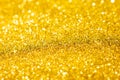 Defocused abstract colorful twinkle light background.  Gold glittery bright shimmering background Royalty Free Stock Photo