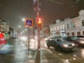 Defocused abstract image. Bokeh effect. Blurred background. Evening cityscape in rainy weather. Cars and night lights Royalty Free Stock Photo