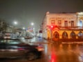 Defocused abstract image. Bokeh effect. Blurred background. Evening cityscape in rainy weather. Cars and night lights Royalty Free Stock Photo