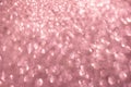 Defocused abstract pink twinkle light background. Pink gold glittery bright shimmering background