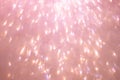 Defocused abstract pink twinkle light background. Pink gold glittery bright shimmering background