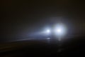 defocused alone minivan moving on empty night foggy road Royalty Free Stock Photo