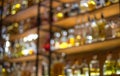 Defocused background of bar counter with various bottles of alcohol