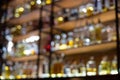 Defocused background of bar counter with various bottles of alcohol