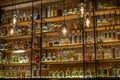 Defocused background of bar counter with various bottles of alcohol