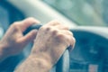 Defocused background of the driver`s hand with blue toning. Male hands on the steering wheel driving a car Driving a car Royalty Free Stock Photo