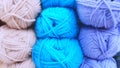 Defocused background of soft balls of wool in blue colors. The concept of coziness and comfort.