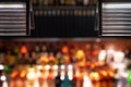 Defocused bar counter with backlit bottles in the background