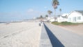 Defocused beachfront house on waterfront walkway, ocean beach in California, USA