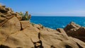 Defocused. Beautiful azure sea and the rocky beach