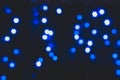 Defocused blue lights with stars shape on dark blurred background with bokeh effect for wallpaper Royalty Free Stock Photo