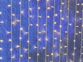 Defocused and blur image of garland of blue led lights on the wall with wide angle view