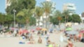 Defocused. Blurred crowds of people are relaxing on the city beach