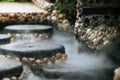 Defocused and blurred image for background. Hot Springs, Boiling and steaming water in geyser vent. Steaming geothermal hot water