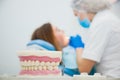 Defocused, blurred image of dentist with patient at clinic office