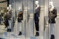 Defocused, blurred showcases display case in fasion department store with dressing-up and festive clothes. Shopping and season