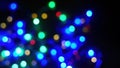 Defocused blurry multicolored blinker lights bokeh of Christmas and New year decoration lights, abstract, dark background, overlay Royalty Free Stock Photo