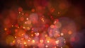 Defocused bokeh background of red and golden glittering sparkles and lights