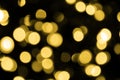 Defocused bokeh christmas gold lights on black background. Royalty Free Stock Photo