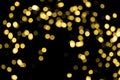 Defocused bokeh christmas gold lights on black background. Royalty Free Stock Photo