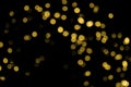 Defocused bokeh christmas gold lights on black background. Royalty Free Stock Photo