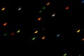 Halloween background. Defocused bokeh multicolor lights in shape of bats on black background. Halloween background.