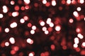 Defocused bokeh red small lights on dark background. Blurred abstract red glitter wallpaper. Red bokeh glitter Royalty Free Stock Photo