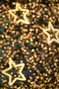 Defocused bokeh and star. Twinkling light warm tone bokeh abstract background for Christmas and Happy new year holiday. Festive e Royalty Free Stock Photo