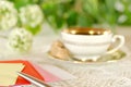 Defocused breakfast table in the garden with writing belongings Royalty Free Stock Photo