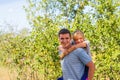 Defocused brother giving sister ride on back. Portrait of happy girl on man shoulders, piggyback. Family playing outside Royalty Free Stock Photo