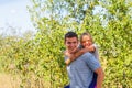 Defocused brother giving sister ride on back. Portrait of happy girl on man shoulders, piggyback. Family playing outside Royalty Free Stock Photo