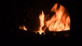 Defocused burning flame with sparks inside rustic furnace
