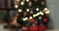 Defocused christmas fairy lights. Out of focus holiday background christmas tree with red santa train Royalty Free Stock Photo