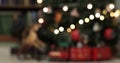 Defocused christmas fairy lights. Out of focus holiday background christmas tree with red santa train Royalty Free Stock Photo