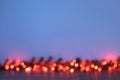 Defocused Christmas garland of red lights on a blue background Royalty Free Stock Photo