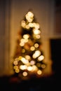 Defocused christmas tree silhouette with blurred lights. Vertical frame Royalty Free Stock Photo