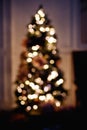 Defocused christmas tree silhouette with blurred lights. Vertical frame Royalty Free Stock Photo