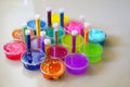 Defocused colorful slimes inside plastic boxes. Set of kids gunk toy, close up view. How to make fluffy slime at home