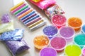 Defocused colorful slimes inside plastic boxes. Set of kids gunk toy, close up view. How to make fluffy slime at home