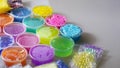 Defocused colorful slimes inside plastic boxes. Set of kids gunk toy, close up view. How to make fluffy slime at home