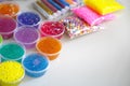 Defocused colorful slimes inside plastic boxes. Set of kids gunk toy, close up view. How to make fluffy slime at home