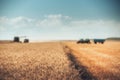 Defocused Combine harvester agriculture machine harvesting gold Royalty Free Stock Photo